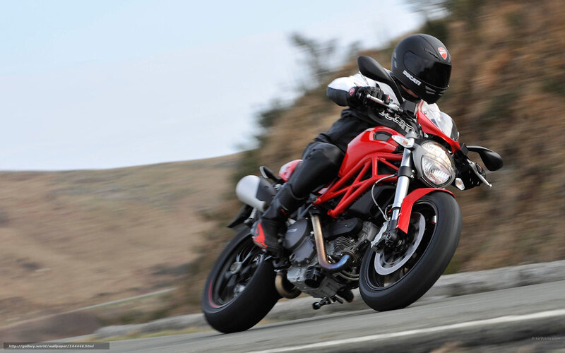 Riding a red motorcycle