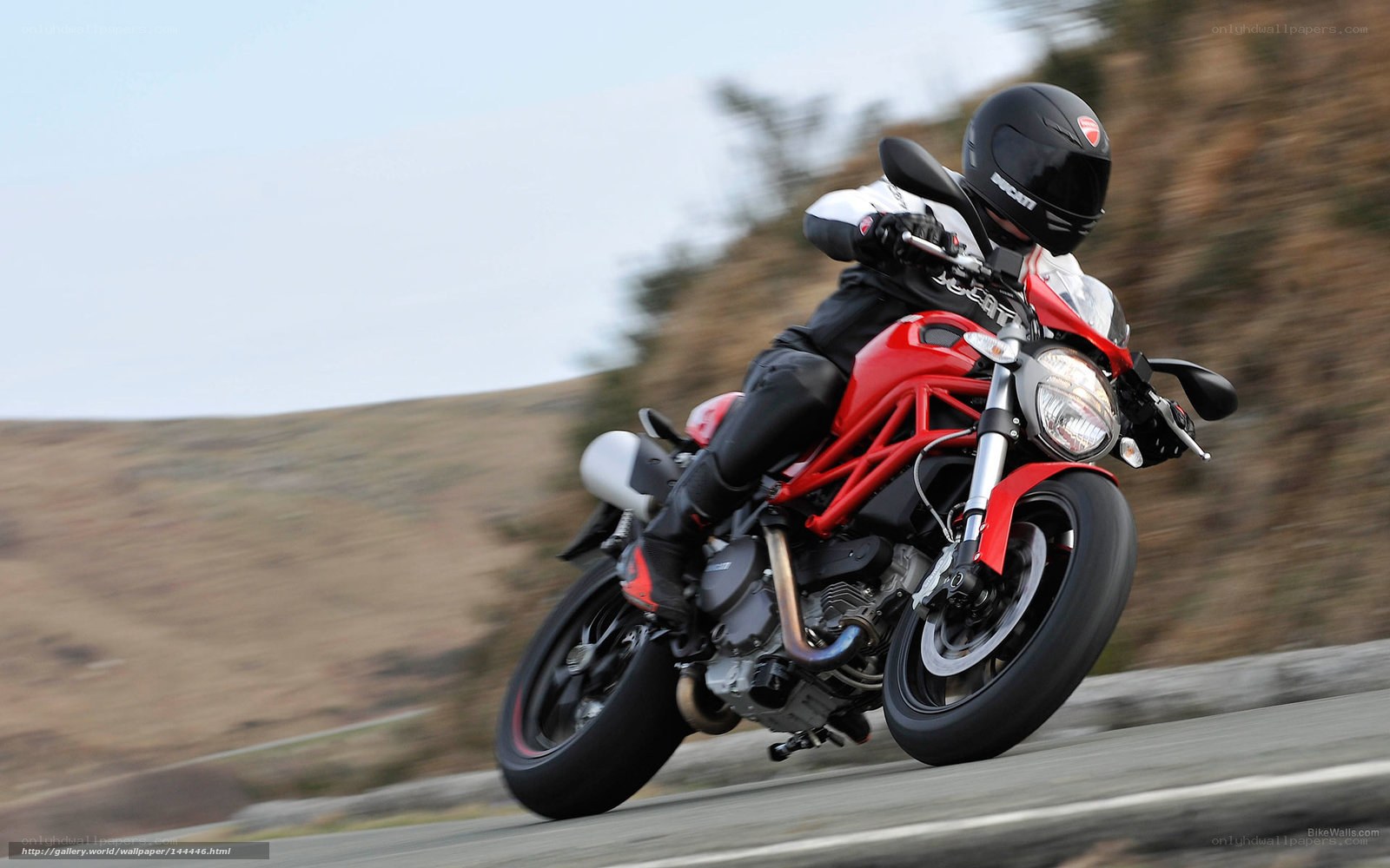Riding a red motorcycle