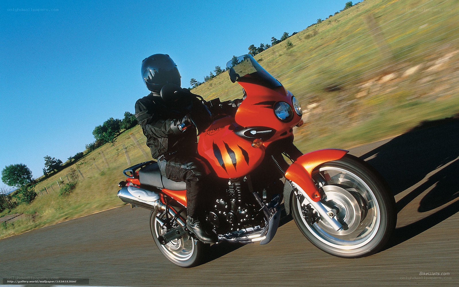 Riding a red motorcycle on a road