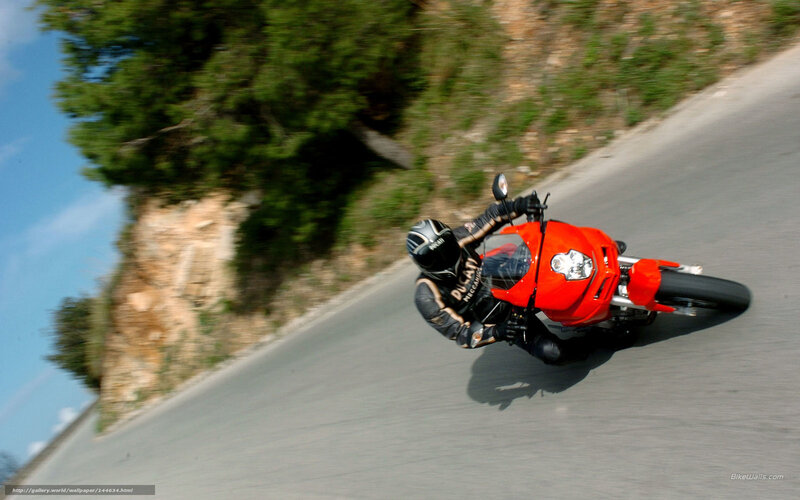 Riding a red motorcycle on a winding road