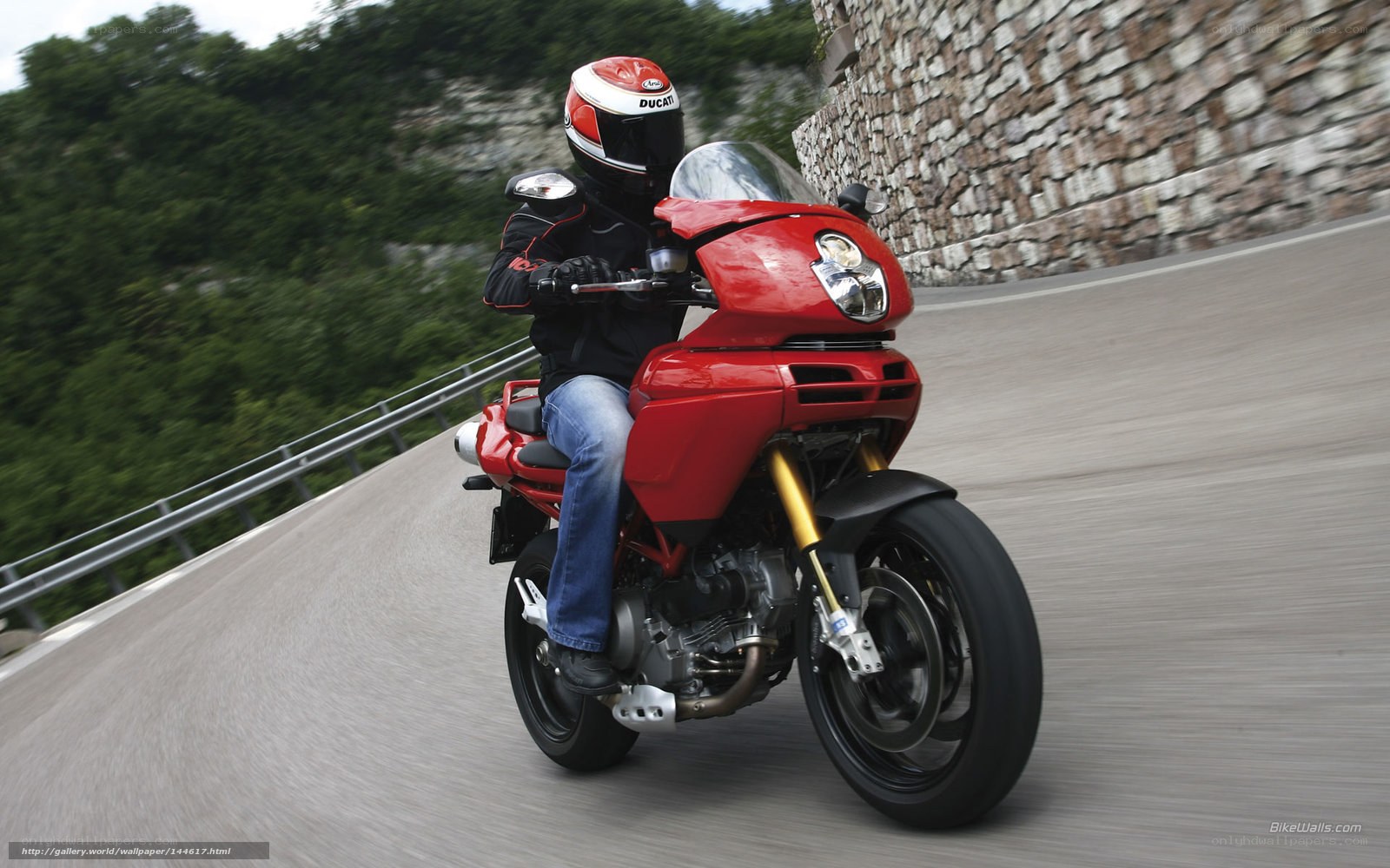 Riding a red motorcycle on a winding road