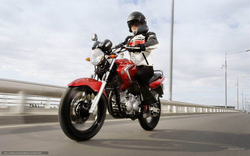 Riding a red motorcycle