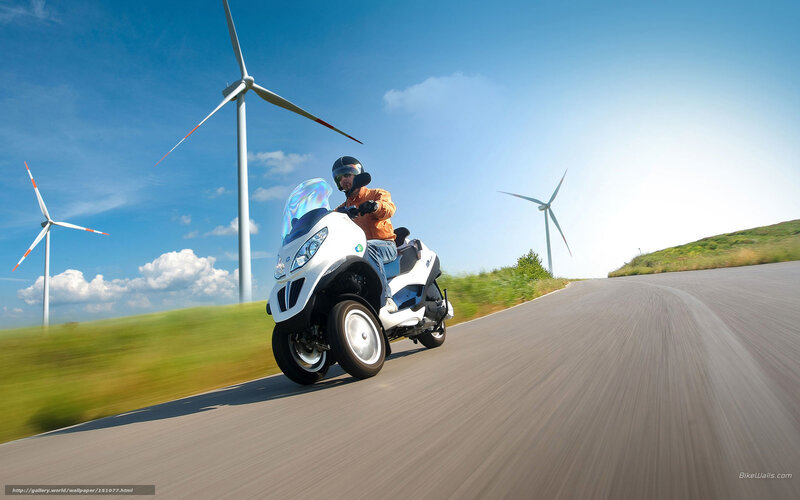 Riding a scooter near wind turbines