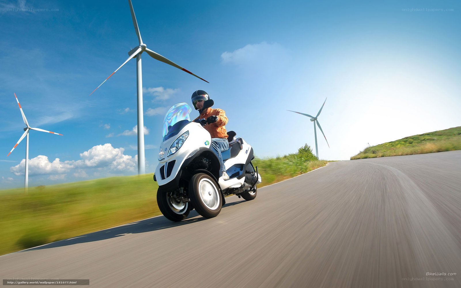 Riding a scooter near wind turbines