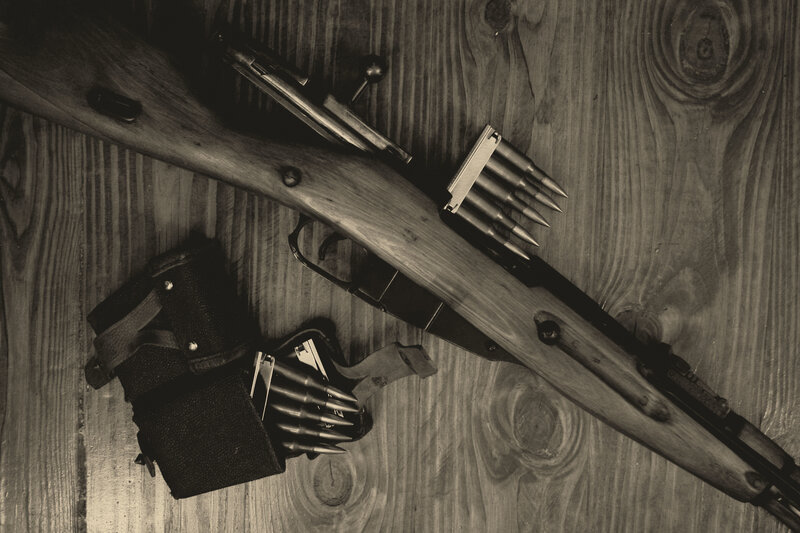 Rifle and ammunition on wood