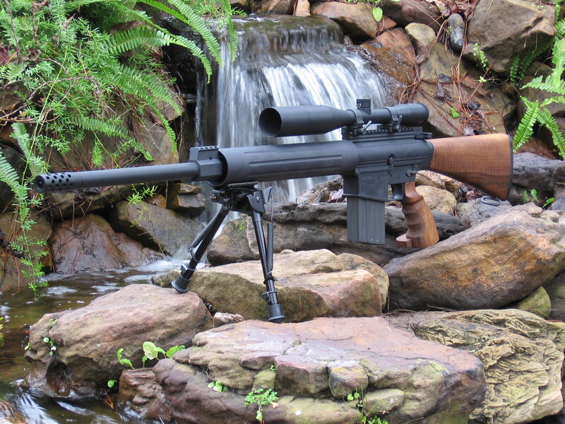 rifle by a waterfall