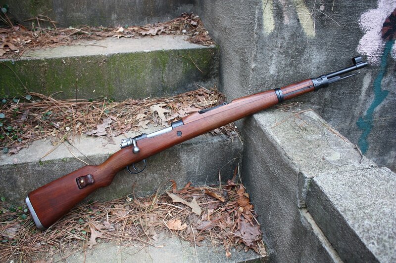 rifle on concrete steps