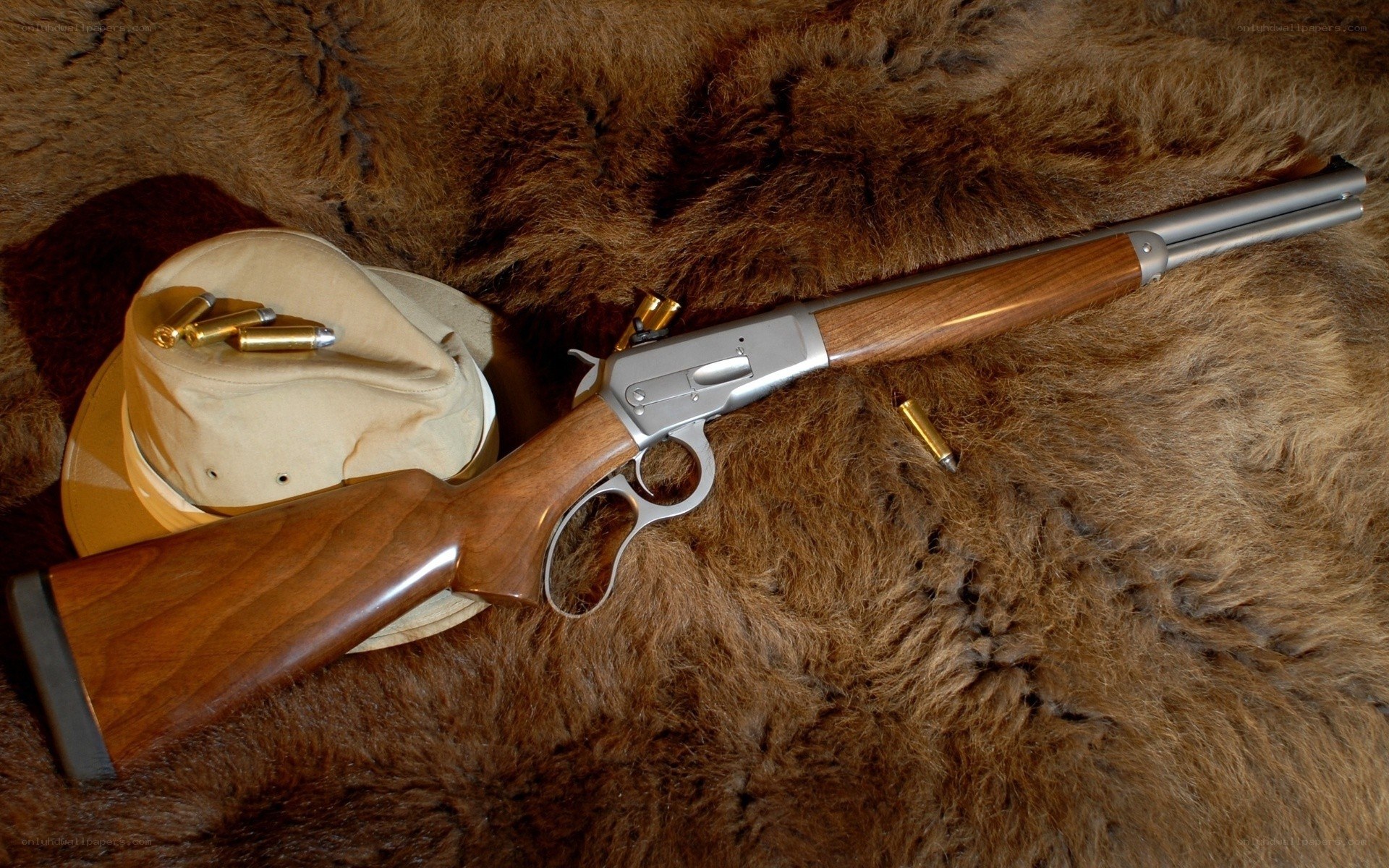 rifle on fur with hat