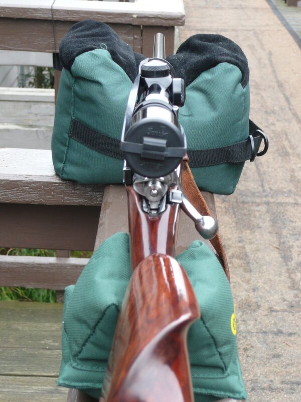 rifle on green bags