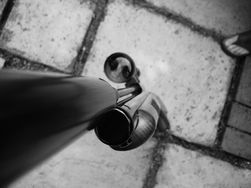 rifle on stone pavement
