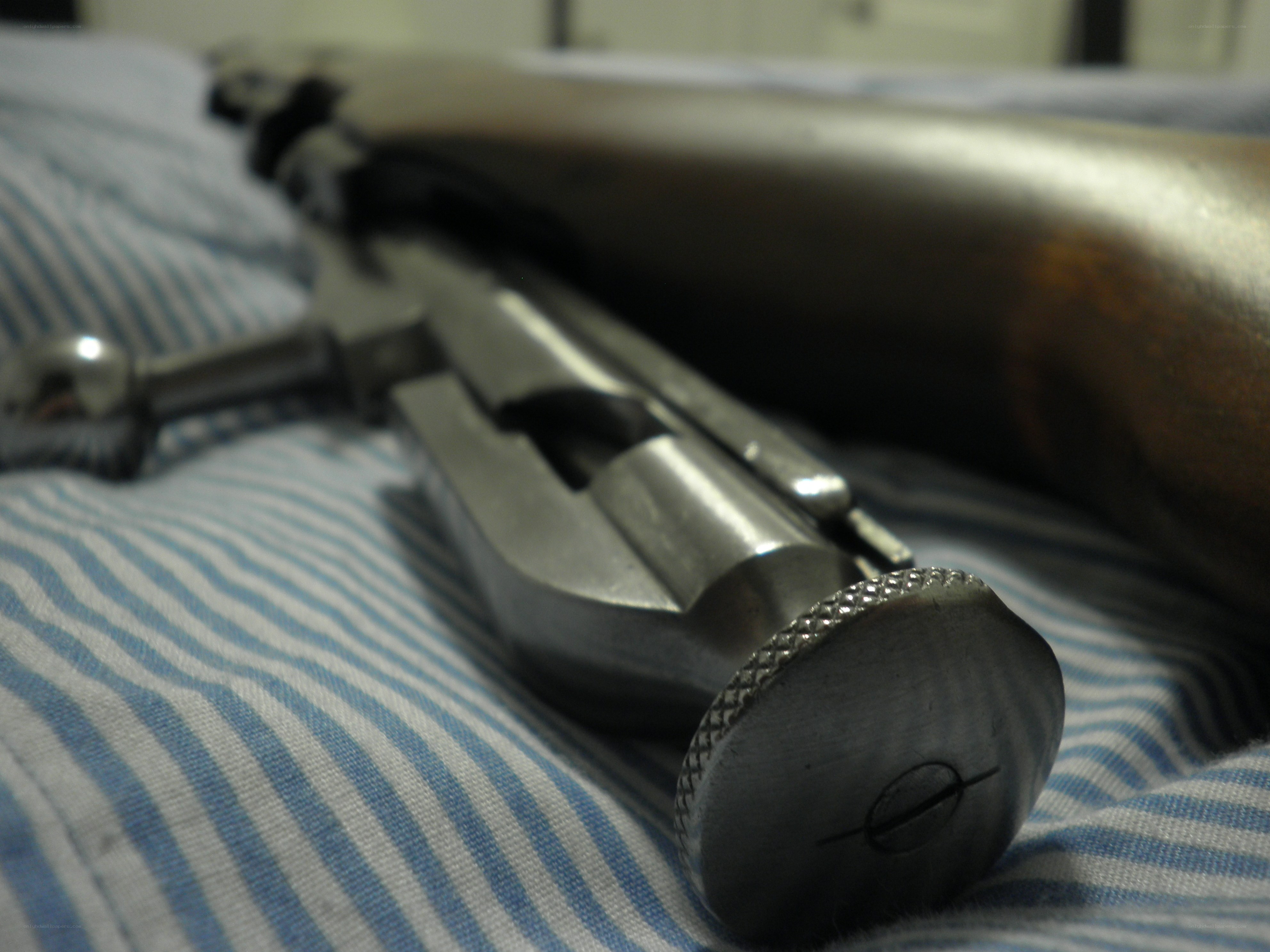 rifle on striped fabric