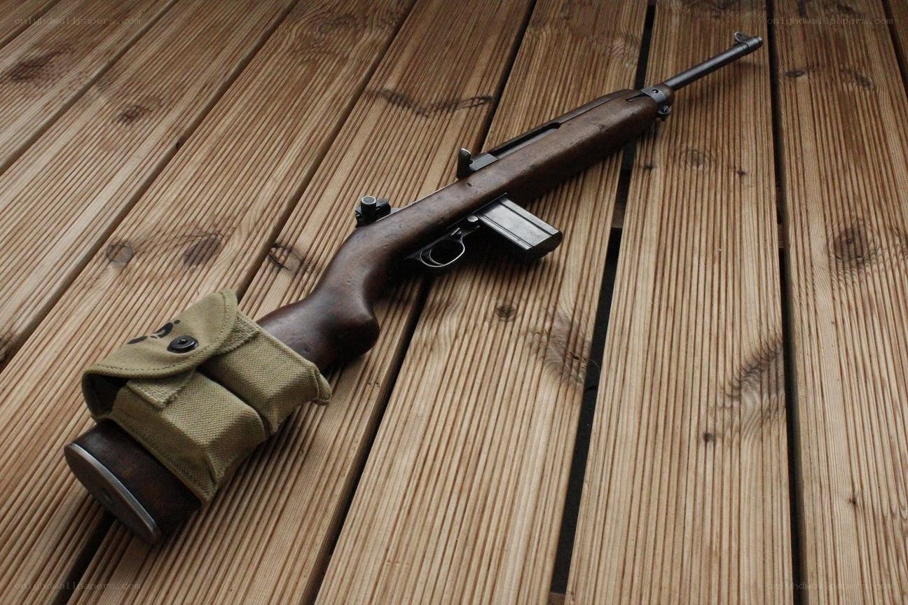 rifle on wooden deck
