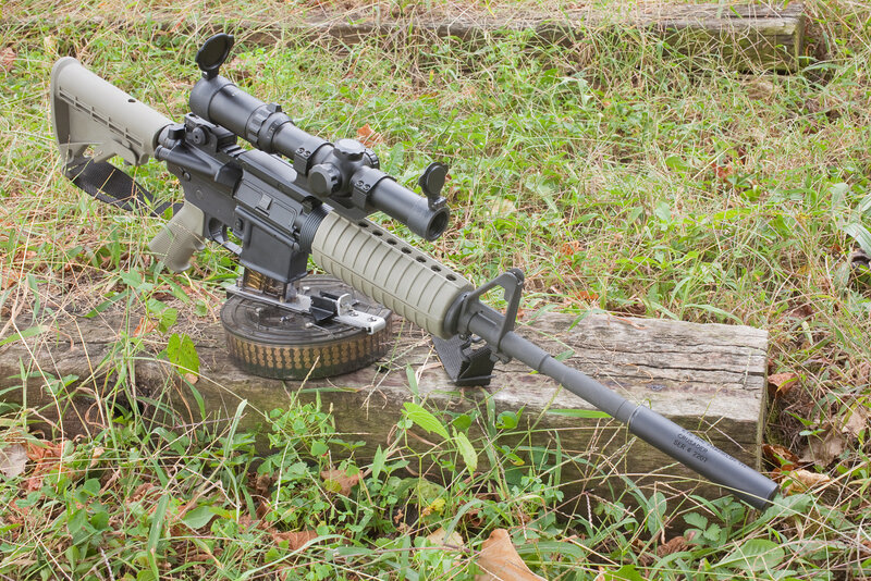 Rifle on Wooden Log