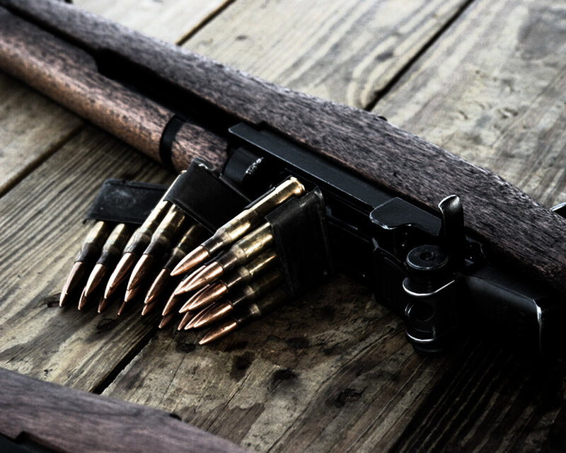 rifle with ammunition on wood