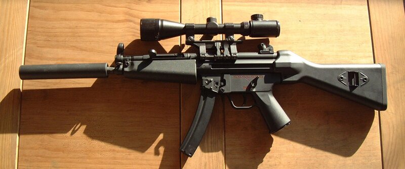 rifle with scope and suppressor