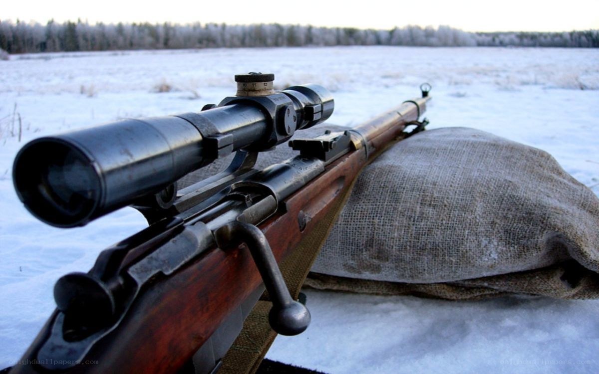 rifle with scope in snow