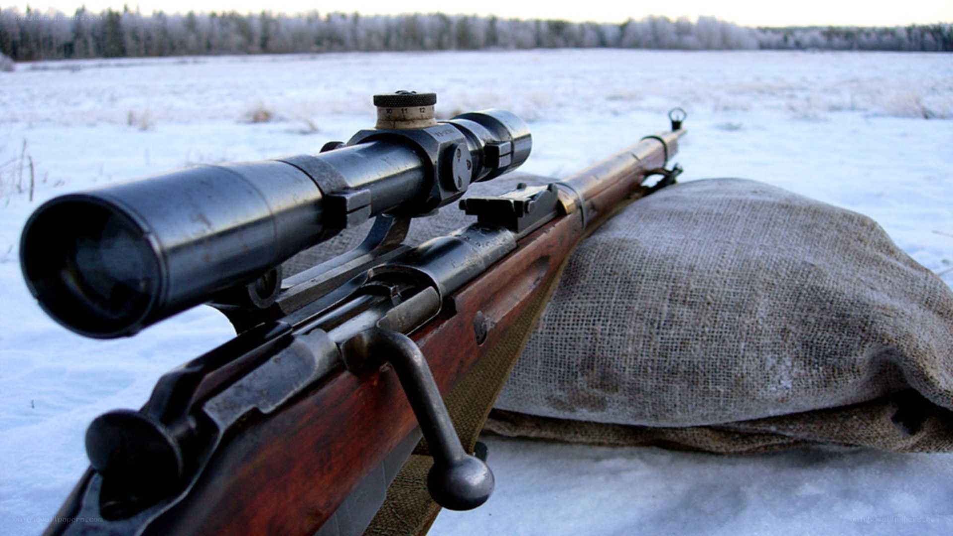 rifle with scope in snow