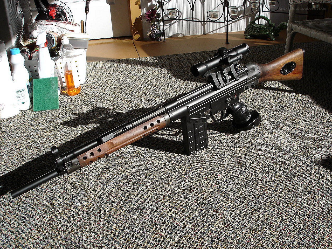 rifle with scope on carpet