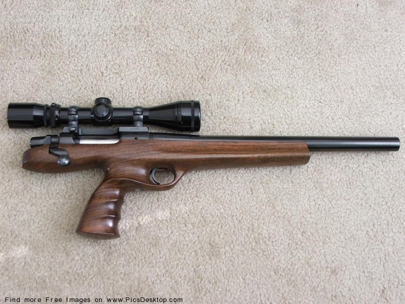 rifle with scope on carpet