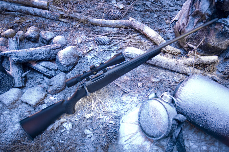 Rifle with Scope on Snow