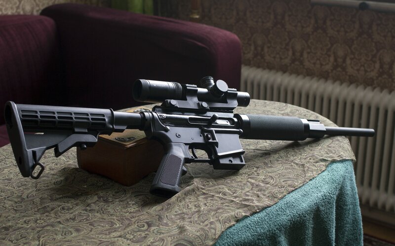 rifle with scope on table