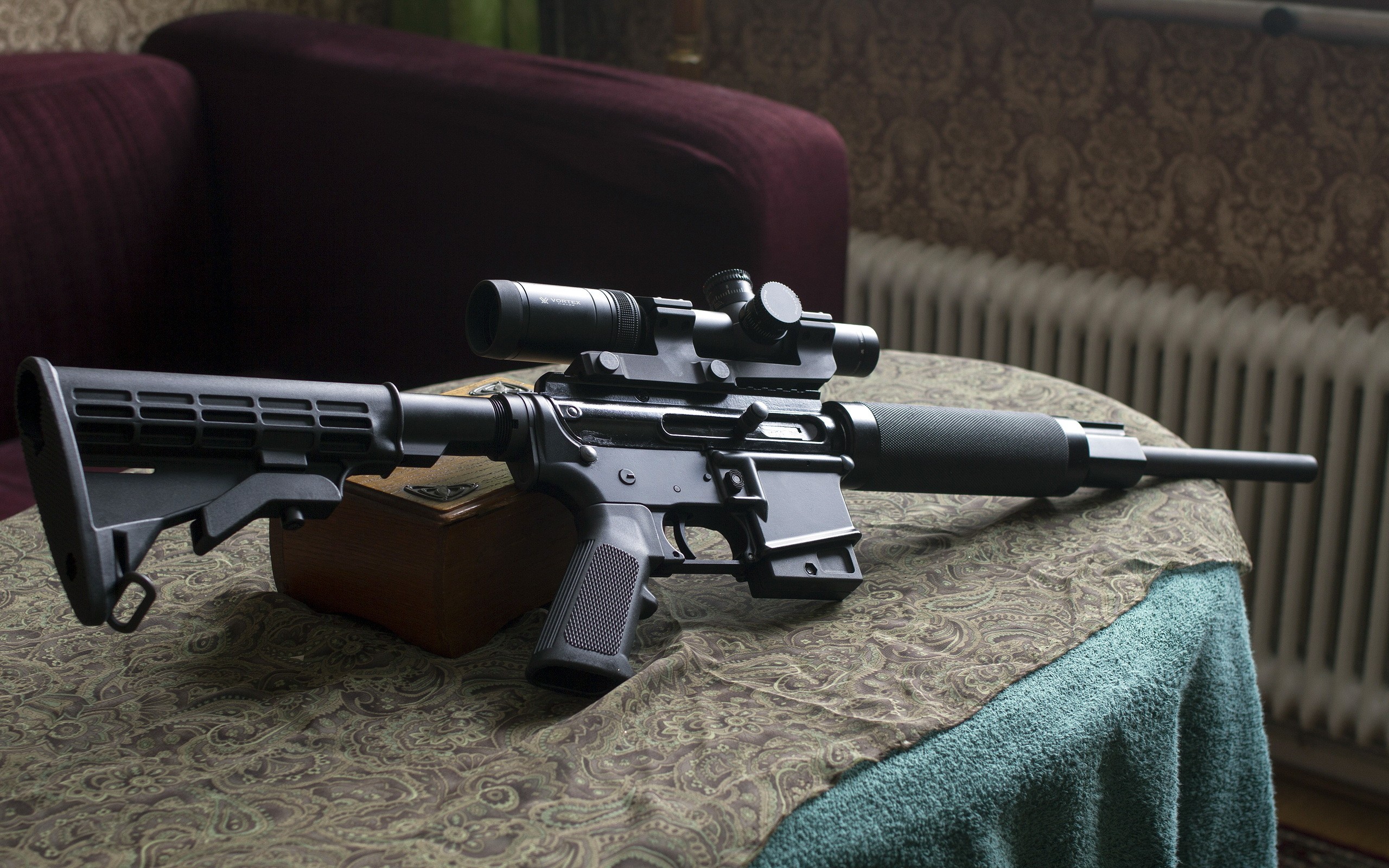 rifle with scope on table