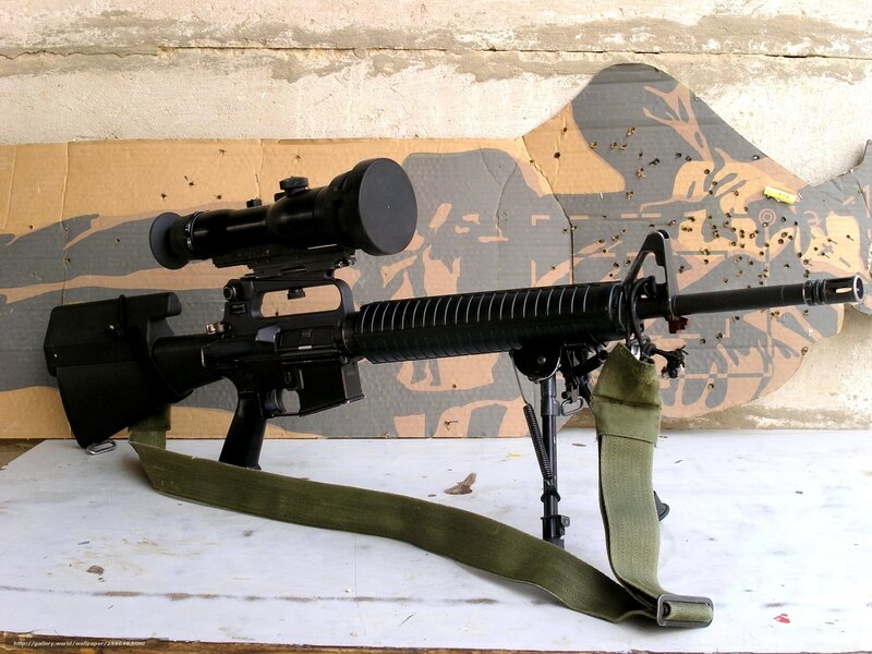 rifle with scope on table