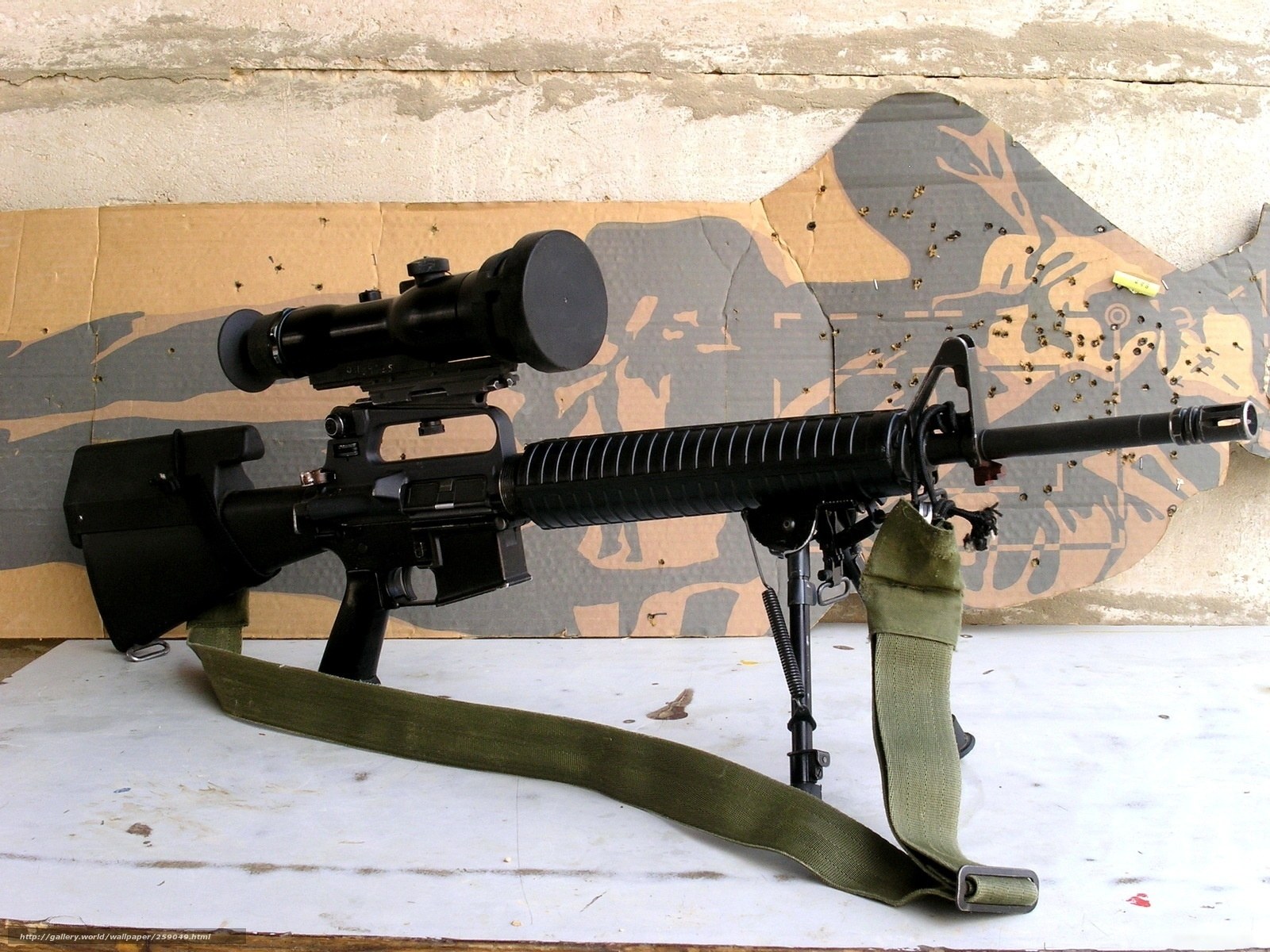 rifle with scope on table