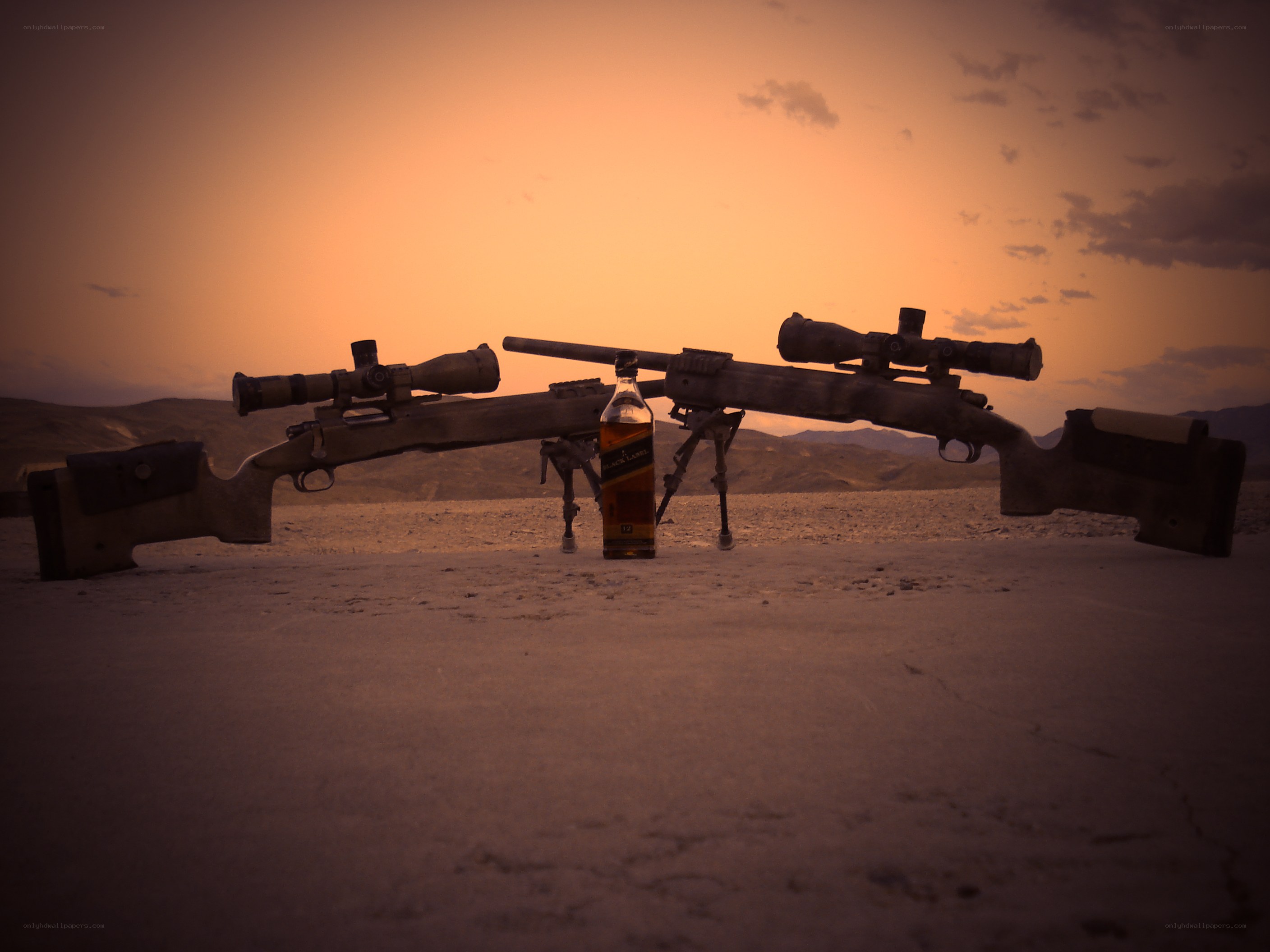 rifles and whiskey at sunset