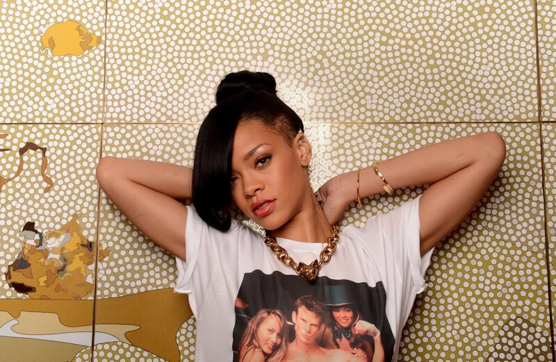Rihanna posing against patterned wall