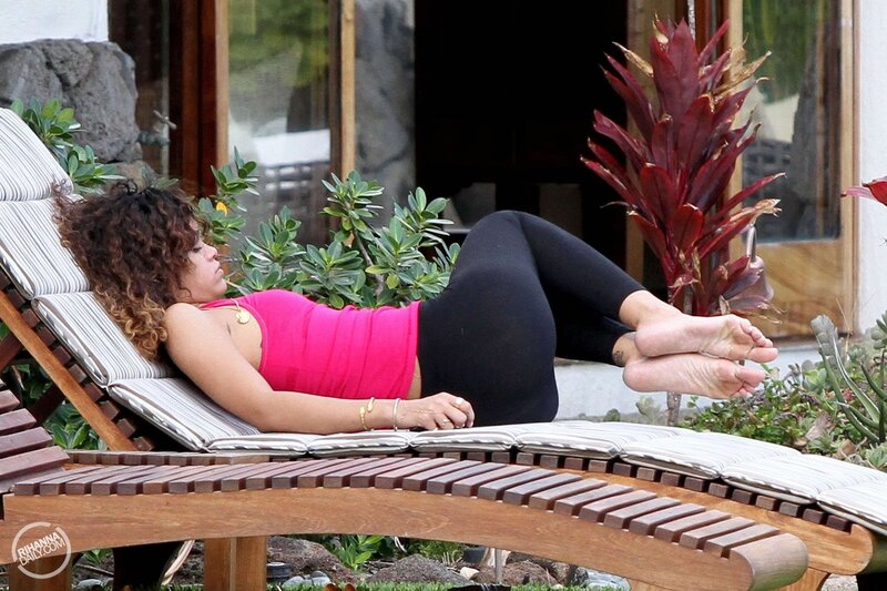 Rihanna relaxing on a lounge chair