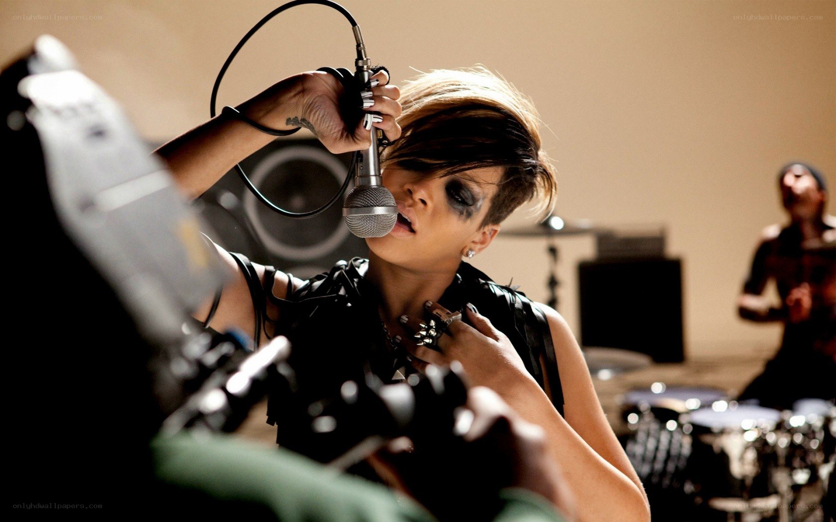 Rihanna singing into microphone