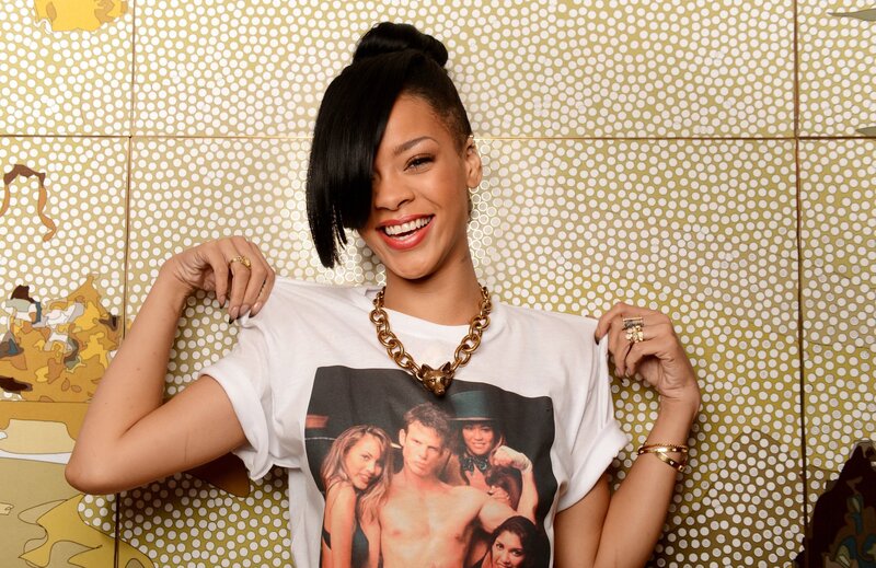 Rihanna smiling in a graphic tee