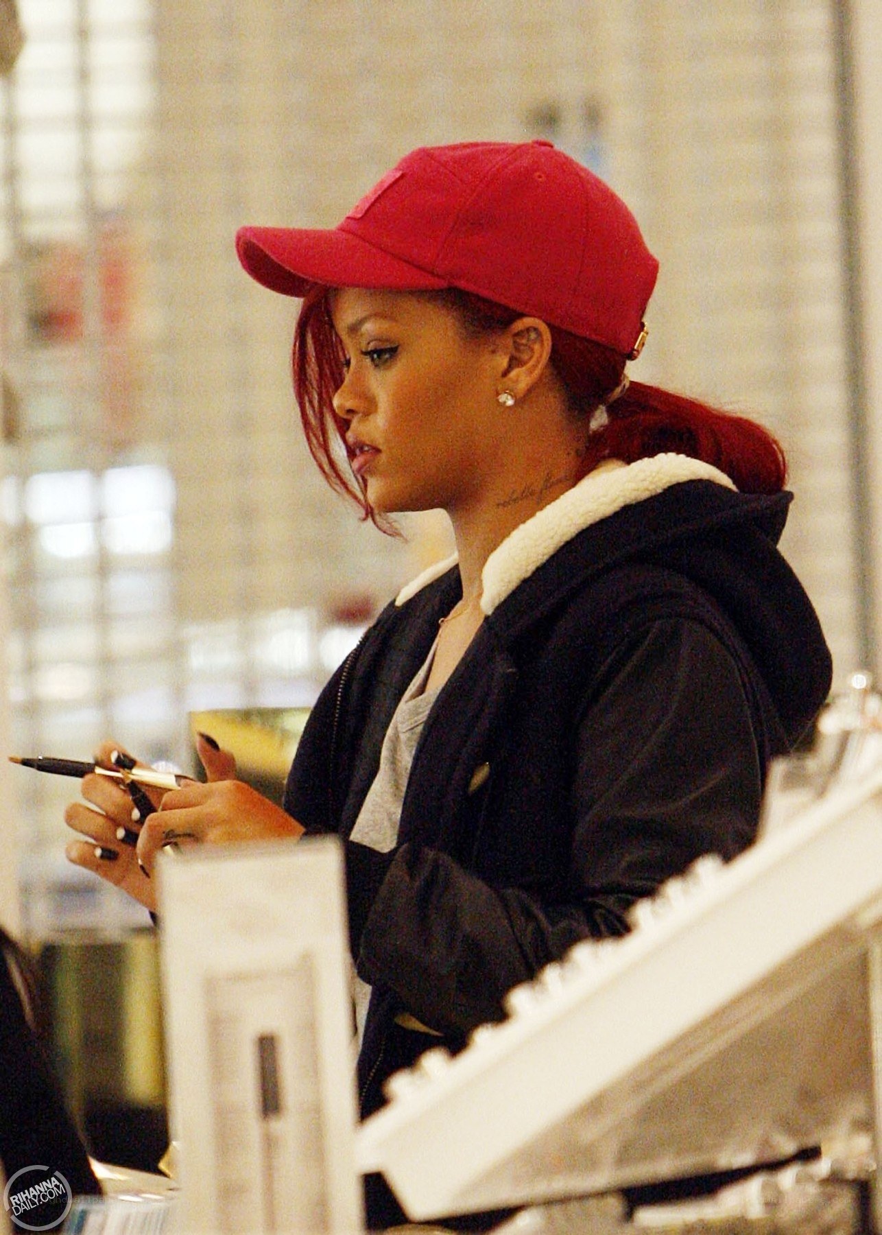 Rihanna wearing red cap
