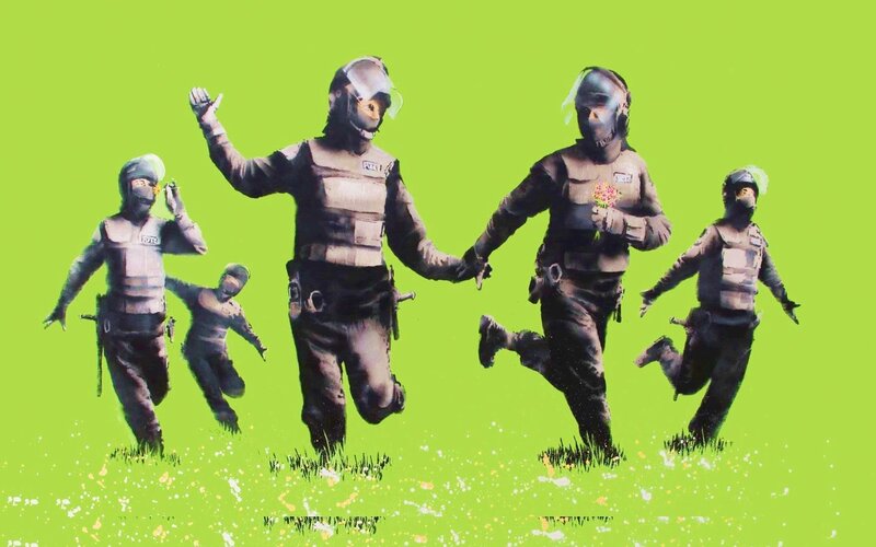 Riot police running with flowers
