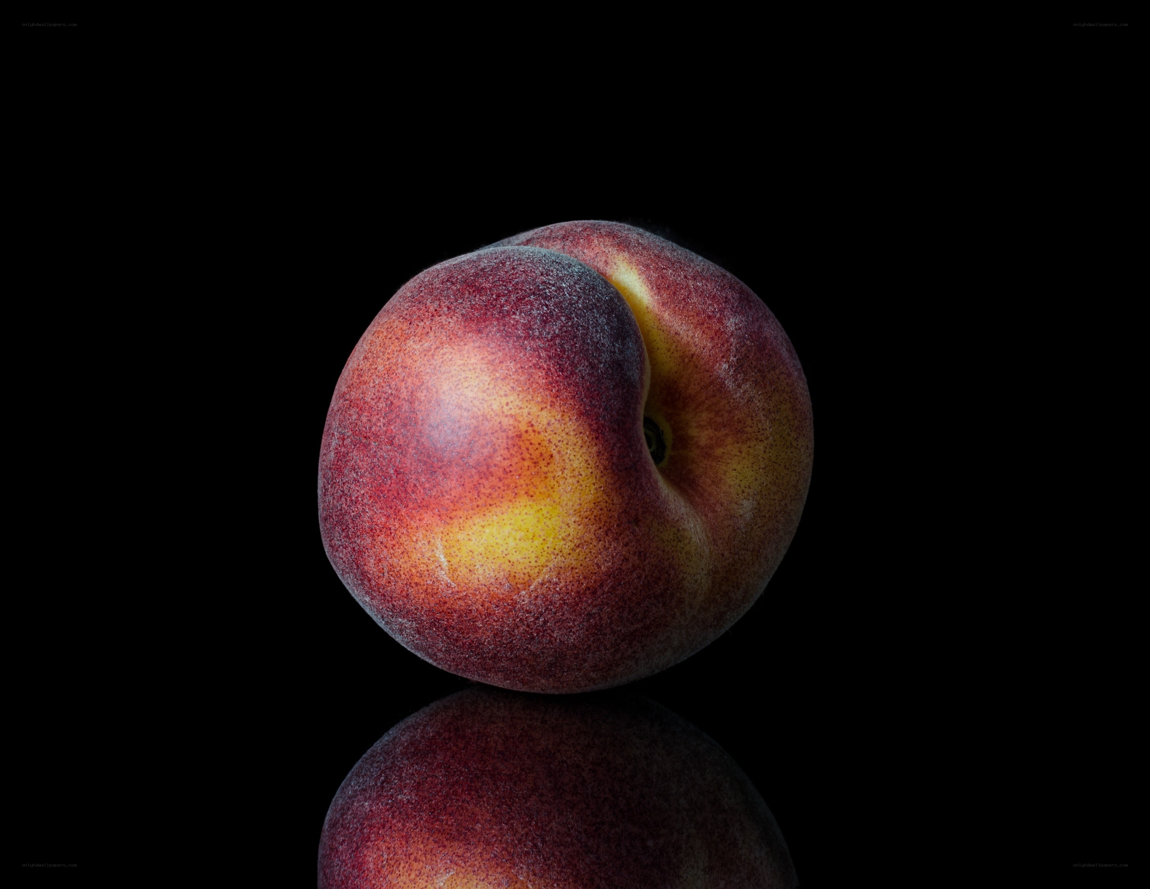 Ripe peach on black background