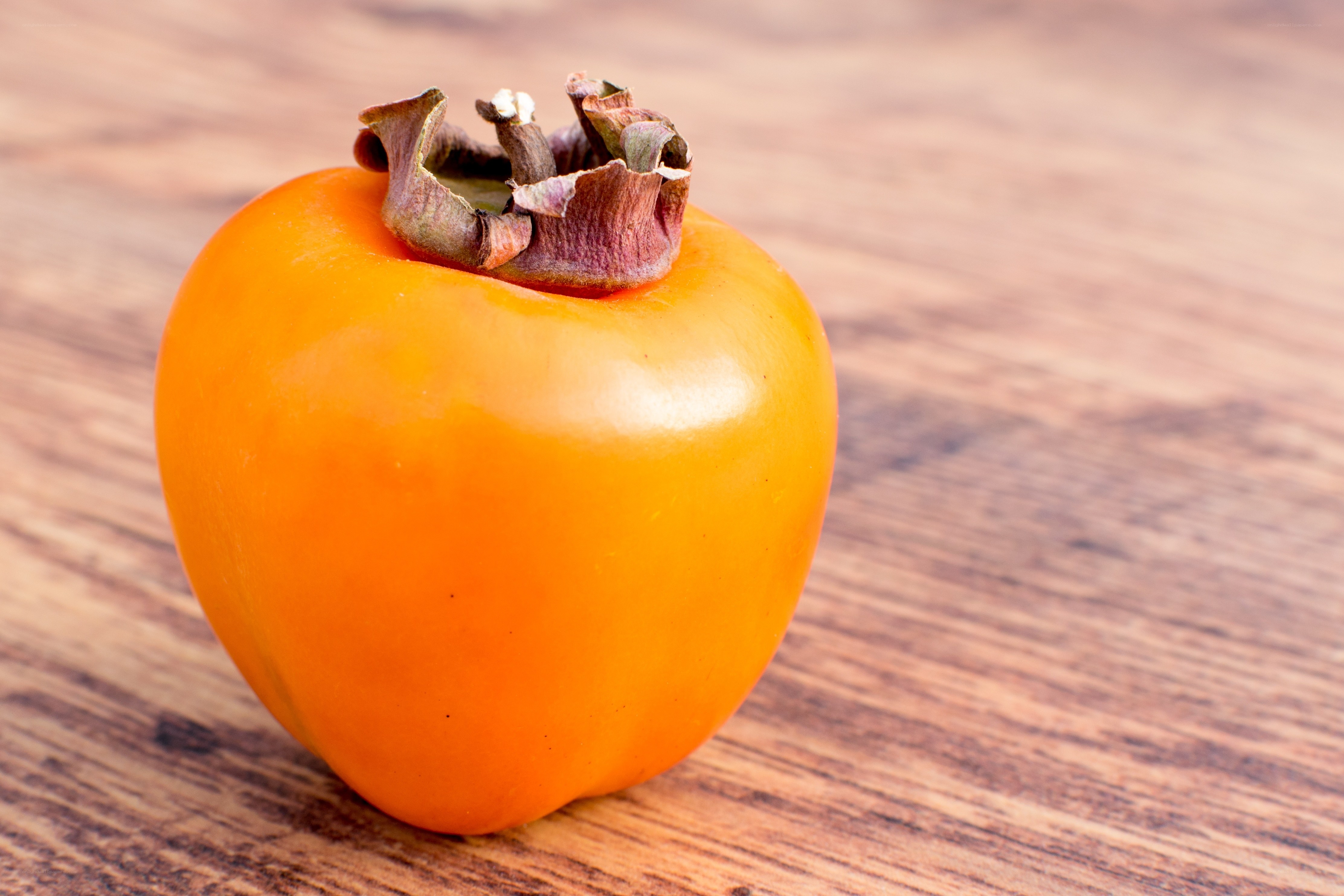 Ripe persimmon on wood