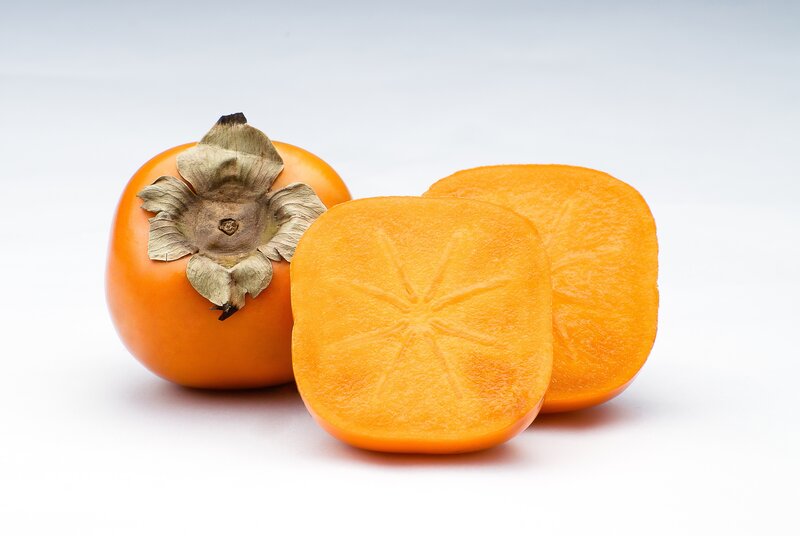 Ripe persimmons on white