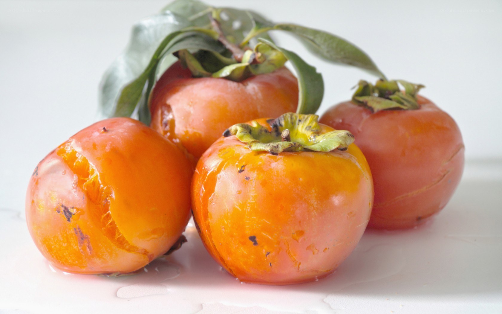 Ripe persimmons with leaves