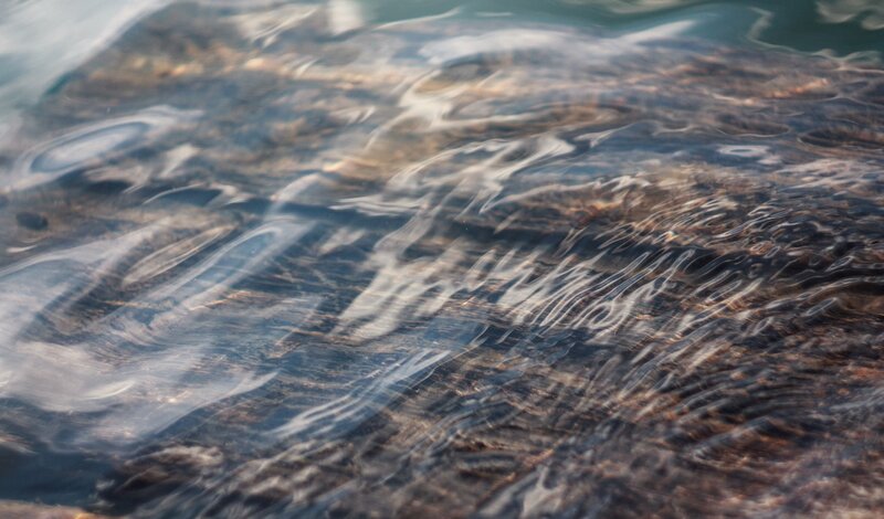 Rippled Water Surface — Blue, Calm, Photograph, Rocks