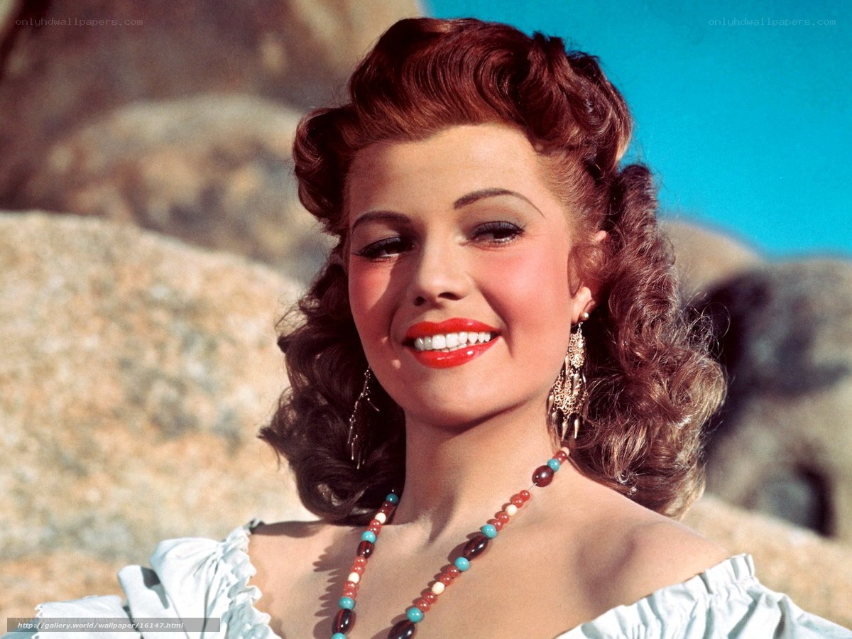 Rita Hayworth smiling outdoors