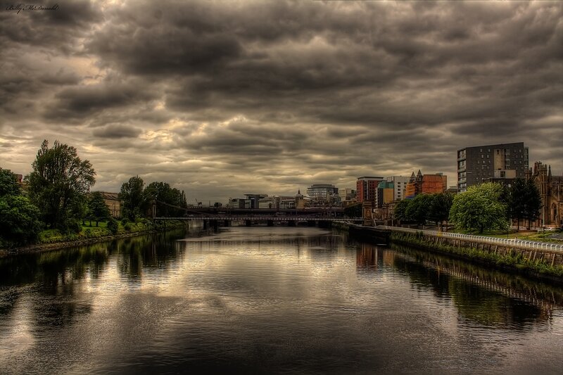 River and city under stormy sky