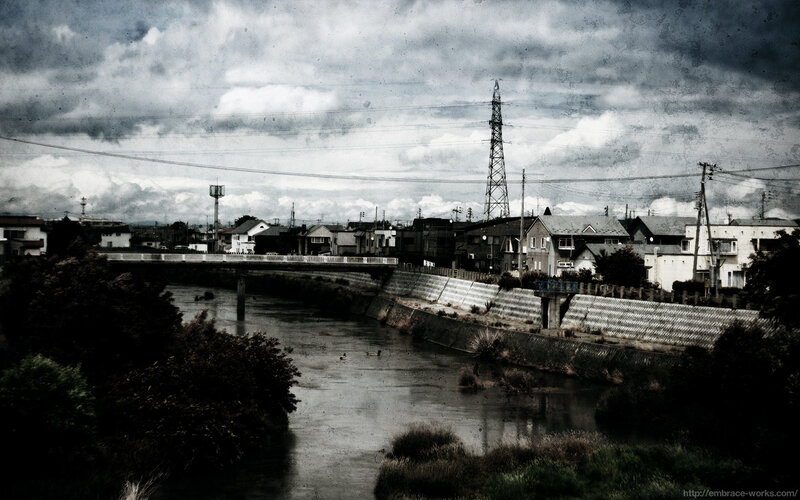 River and town under cloudy sky