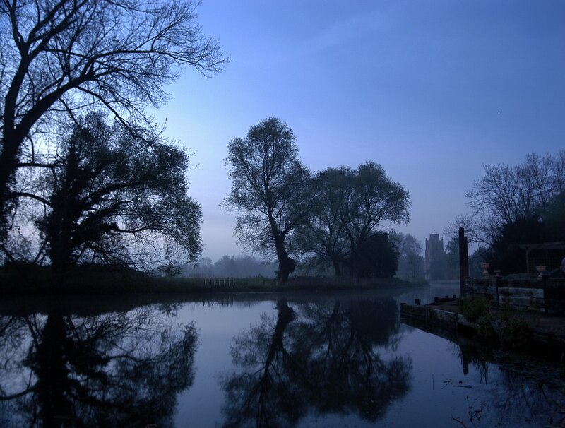 River at dawn with church in distance
