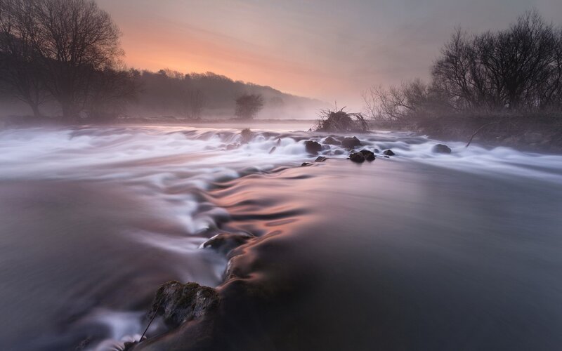 River at dawn with mist