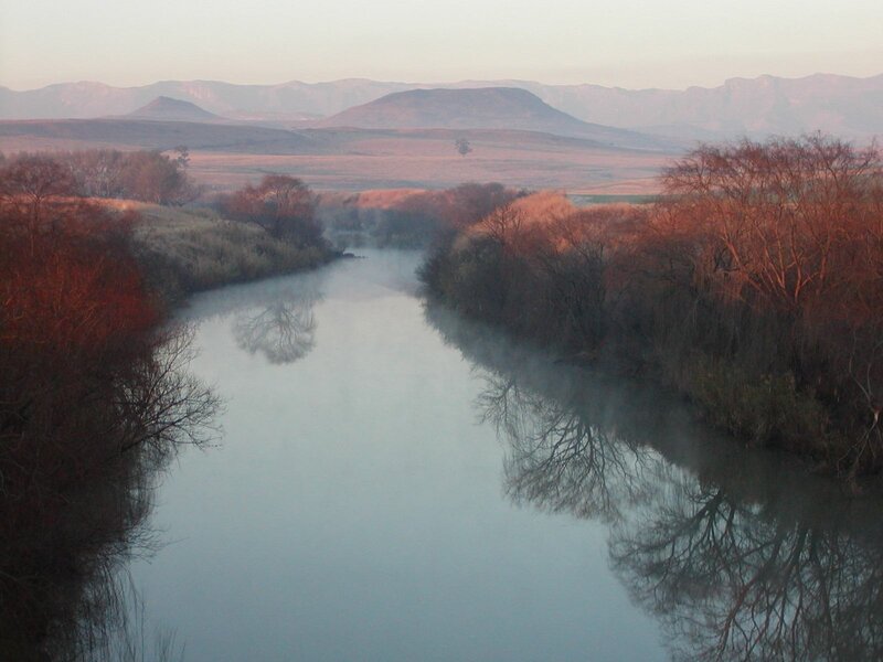 River at dawn with mountain backdrop