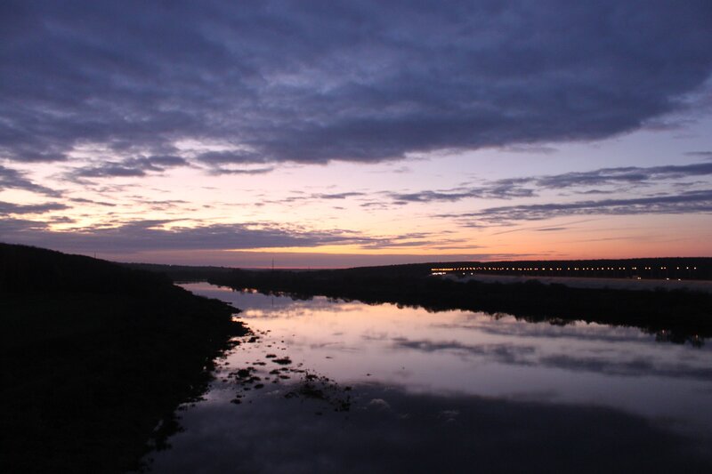 River at dusk with cloudy sky