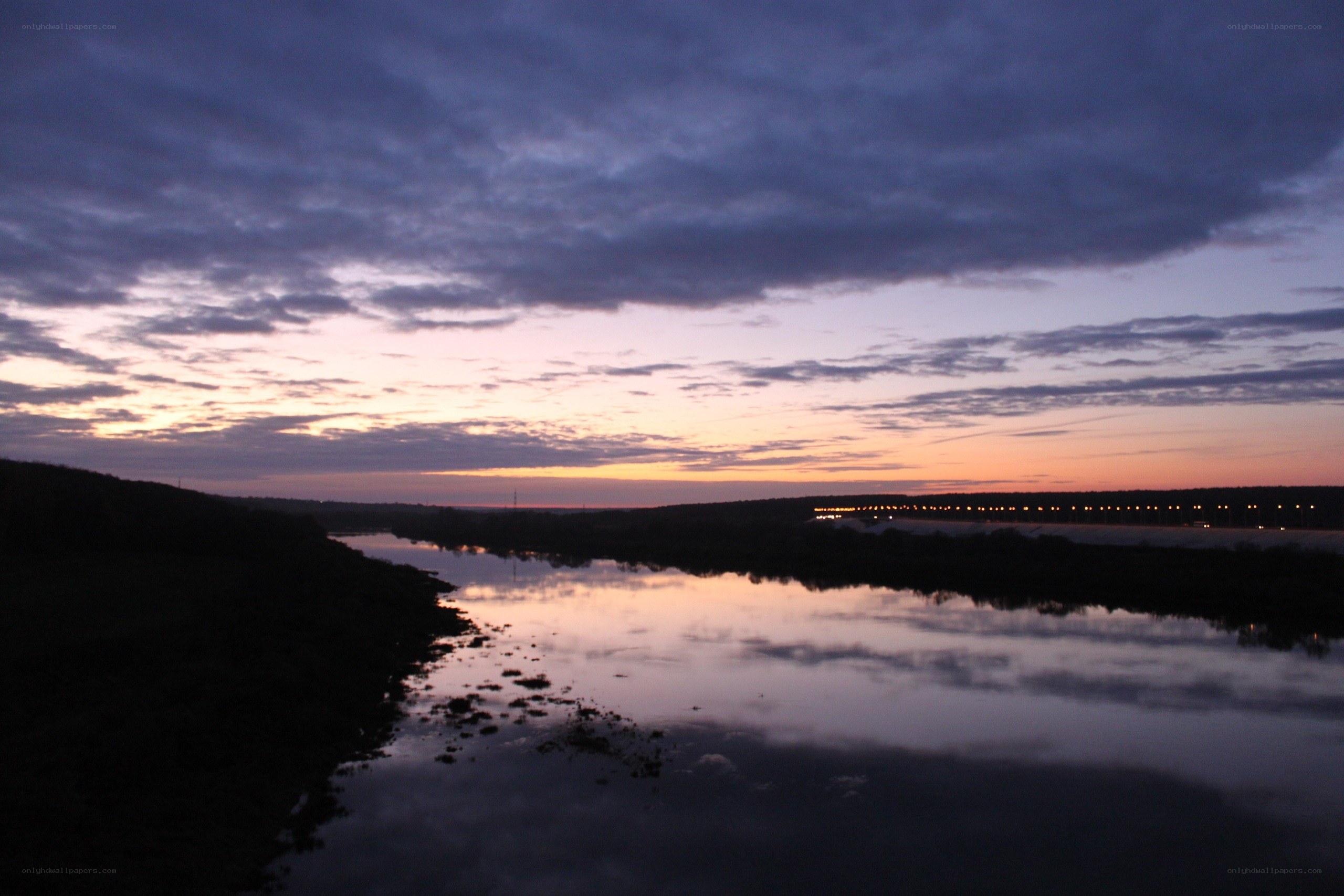 River at dusk with cloudy sky