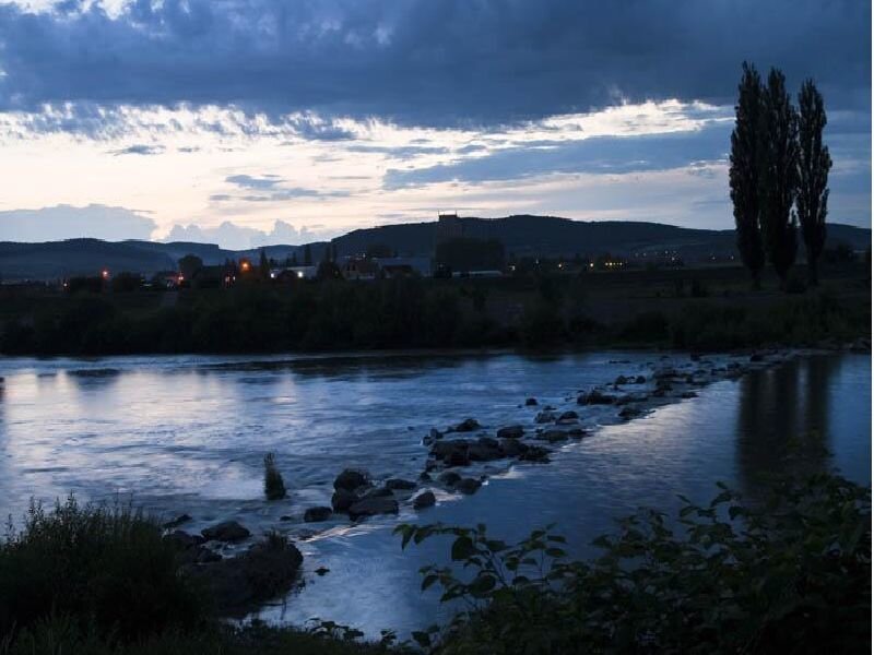 River at dusk with distant town