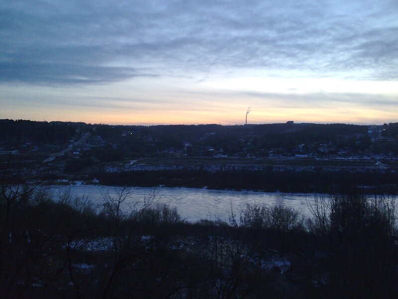 river at dusk with industrial smoke